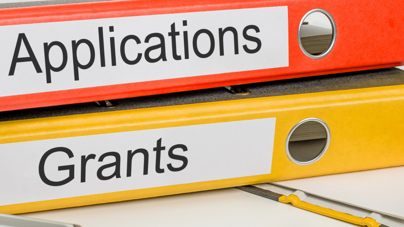 Orange folder marked applications and yellow folder marked grants