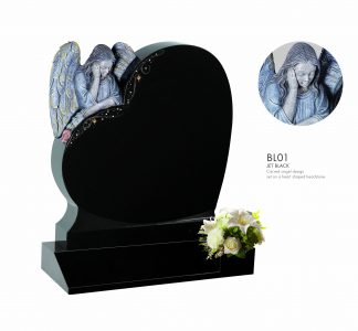 A heart-shaped headstone memorial with an angel looking over the heart