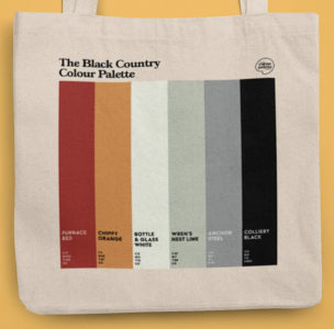 A tote bag printed with the Black Country palette - six vertical stripes of colour in the order red, orange, white, green, grey, black.