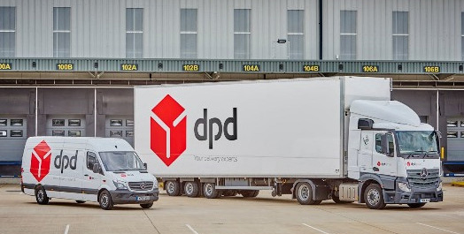 A DPD van and a DPD lorry parked outside a large industrial unit.