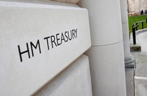 A close up of a white plaque on a white wall saying HM Treasury