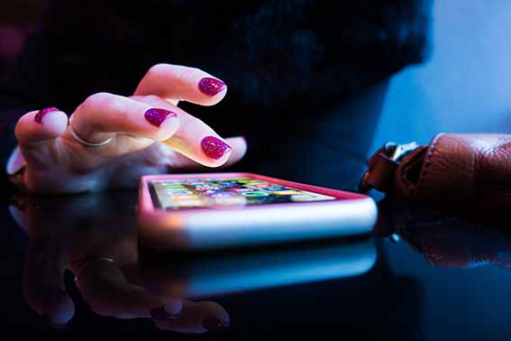 Close up of person typing on a smart phone