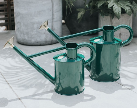 Two dark green Haws watering cans