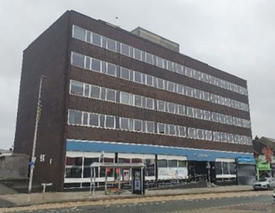 A large brick office building with lots of windows.