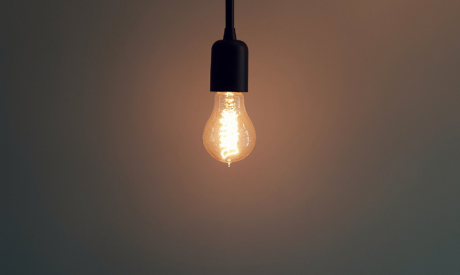 Lone lightbulb hanging from ceiling