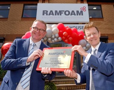 Two men in dark blue suits holding a commemorative plaque in front of a red and white balloon arch outside a building. The building says 'Ramfoam' and the plaque says 'Enterprise House officially opened by Andy Street, Mayor of the West Midlands, 29.07.2021'