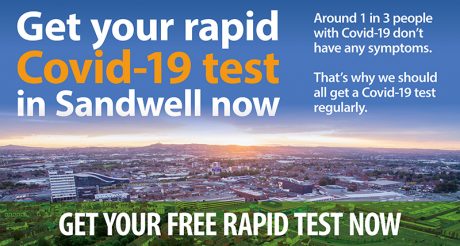 A banner saying "Get your rapid Covid-19 test in Sandwell now" on a background image of a distant town and setting sun in the sky with a green field in the foreground