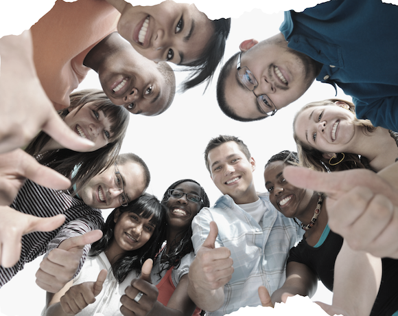 A photo taken from below of ten young smiling people looking down at the camera and giving thumbs up.