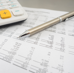 Balance sheet with silver propelling pencil and a calculator