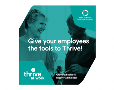 An image of two people smiling at each other, tinted green, with white text overlaid saying 'Give your employees the tools to Thrive!'