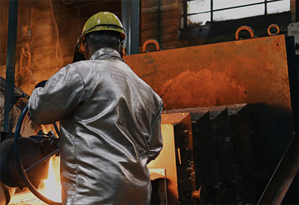 The back of a worker in a foundry