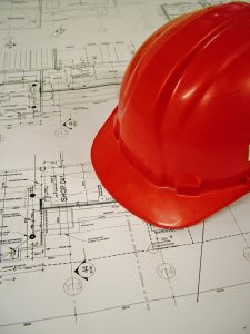 A red hard hat on an architect's drawing