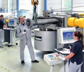 Inside the premises of Sandwell pipe-forming manufacturer Formbend, with three machinery operators