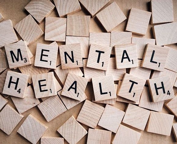 Scrabble tiles spelling out 'mental health'